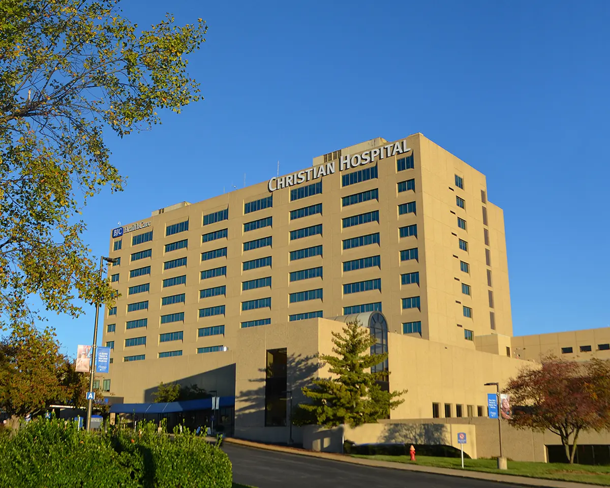 CHN-1200x960 Photograph of the multi-story Christian Hospital building under a clear blue sky, with trees and landscaping in the foreground and the hospital entrance and signage visible, representing Dr. Ali Dalal’s Christian Hospital practice location for orthopedic and joint replacement care